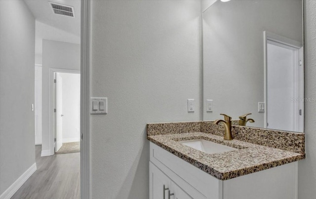 bathroom with vanity and wood-type flooring