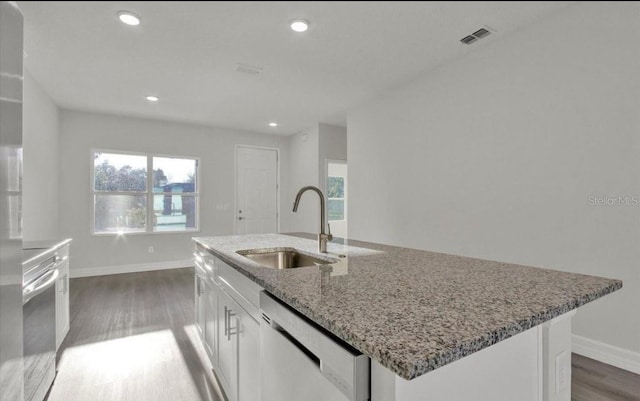 kitchen featuring stainless steel dishwasher, a healthy amount of sunlight, white cabinets, and sink