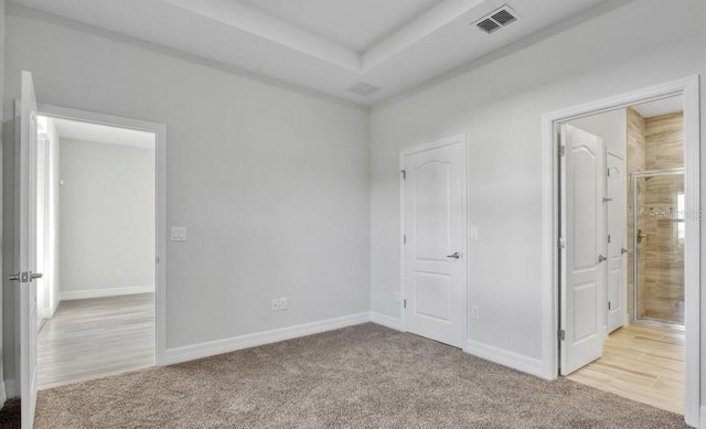 unfurnished bedroom featuring light carpet