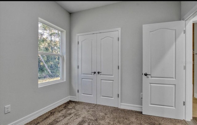 unfurnished bedroom with carpet and a closet