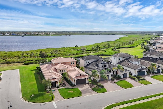 birds eye view of property with a water view