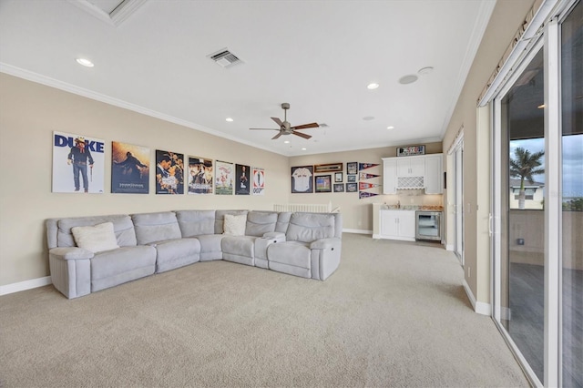 living room featuring crown molding, light colored carpet, and beverage cooler