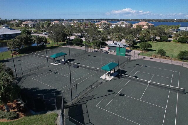 view of tennis court with a water view