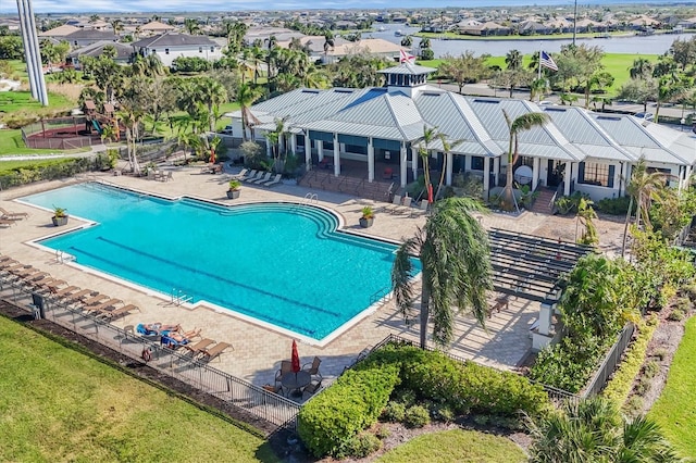 view of swimming pool with a water view and a patio area