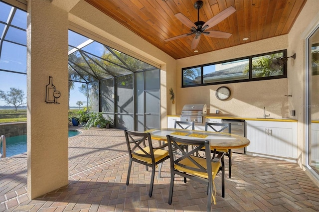 sunroom / solarium featuring wood ceiling and sink