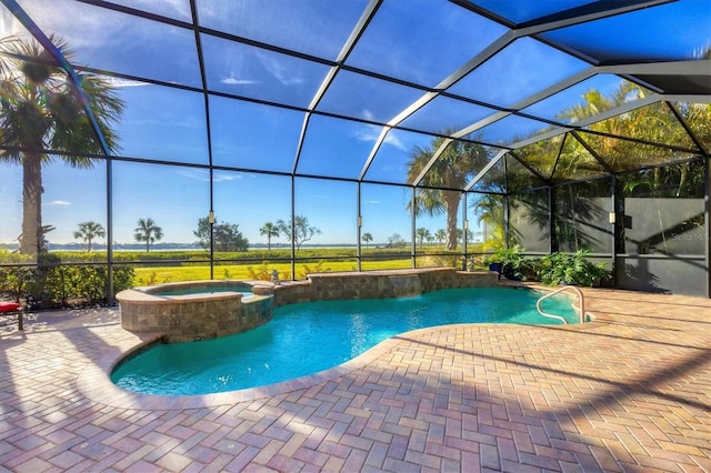 view of pool featuring a patio area, an in ground hot tub, and glass enclosure