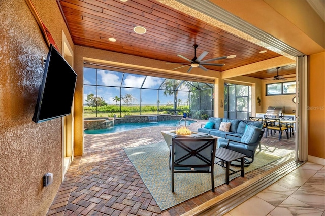 view of patio featuring area for grilling, an outdoor living space with a fire pit, pool water feature, and glass enclosure