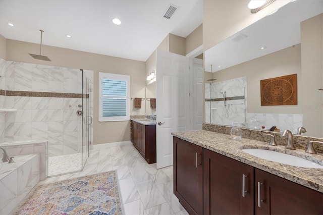 bathroom featuring shower with separate bathtub and vanity