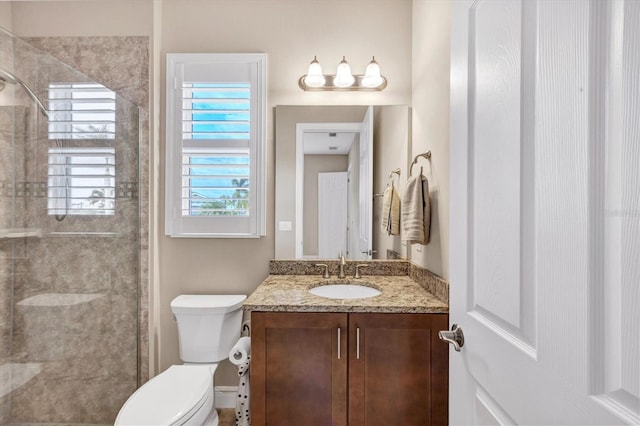 bathroom with vanity, a shower, and toilet