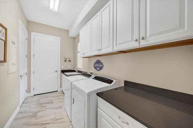 washroom featuring independent washer and dryer, cabinets, and sink