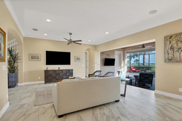 living room featuring crown molding and ceiling fan