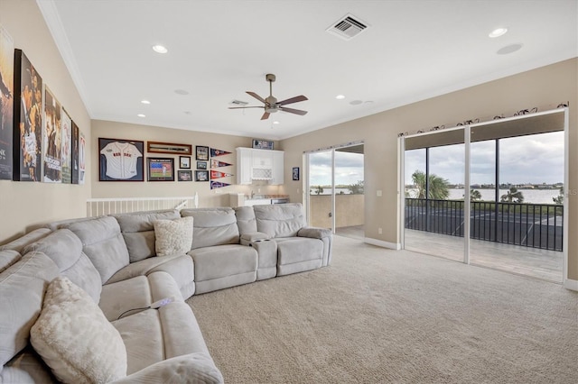 living room featuring light colored carpet, ornamental molding, and ceiling fan