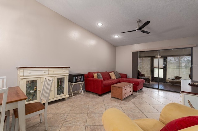 tiled living room featuring lofted ceiling, a textured ceiling, and ceiling fan