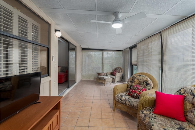 sunroom featuring a drop ceiling and ceiling fan