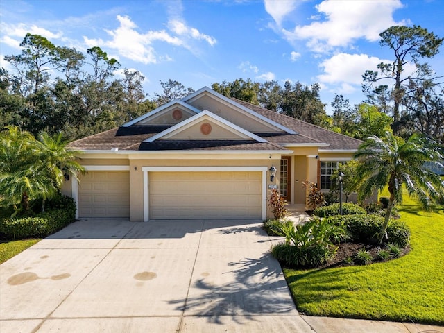 view of front of house with a front yard and a garage