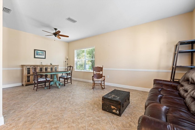 living room featuring light tile patterned floors and ceiling fan