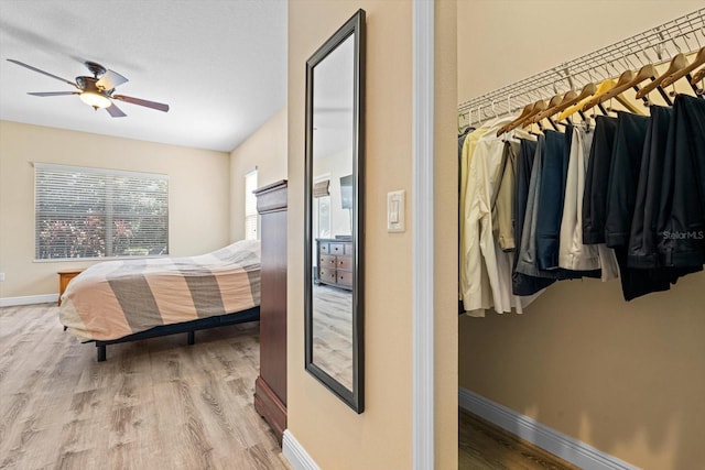 bedroom with ceiling fan and wood-type flooring