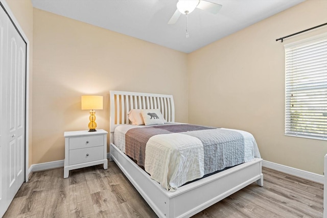 bedroom featuring light hardwood / wood-style flooring, a closet, and ceiling fan