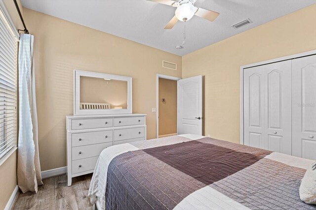 bedroom featuring a closet, ceiling fan, and light hardwood / wood-style flooring