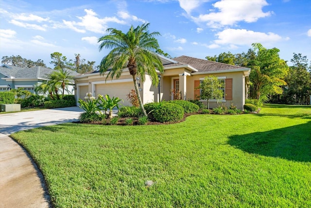 view of front of property featuring a front yard and a garage