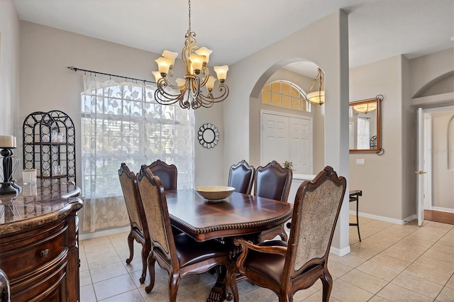 dining space featuring light tile patterned floors and an inviting chandelier