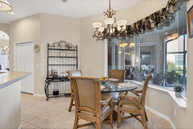 dining area featuring an inviting chandelier and tile patterned flooring