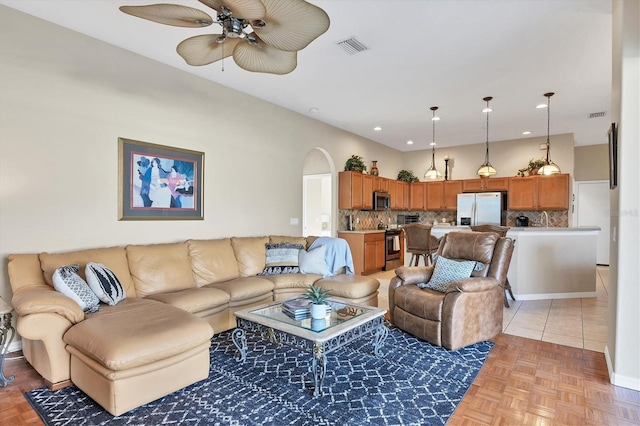 living room with light parquet flooring and ceiling fan