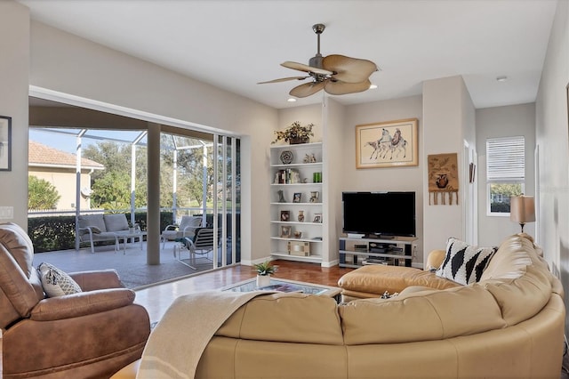 living room with hardwood / wood-style floors and ceiling fan