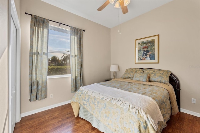 bedroom with dark hardwood / wood-style floors and ceiling fan