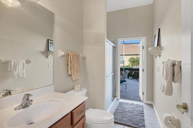 bathroom featuring vanity, toilet, tile patterned flooring, and an enclosed shower