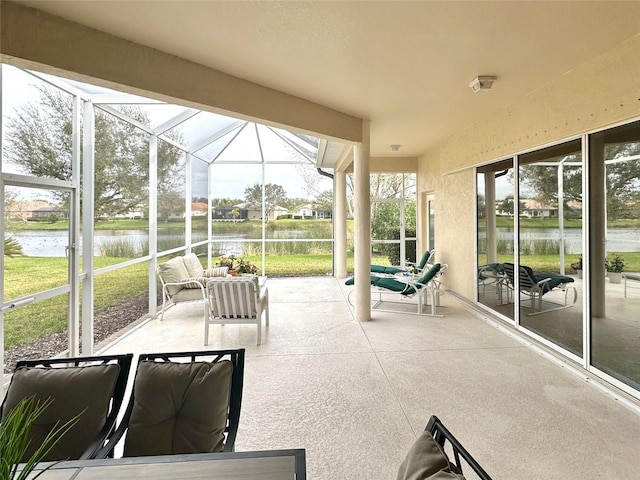 unfurnished sunroom featuring a water view