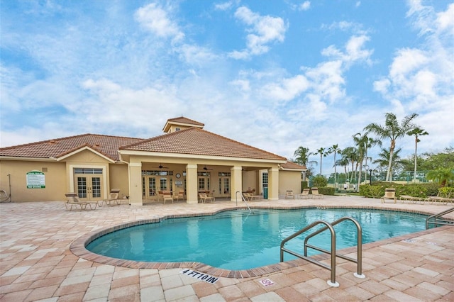 view of swimming pool featuring a patio and ceiling fan