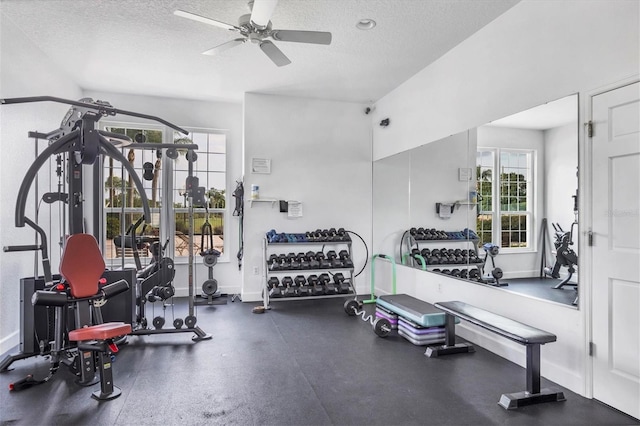 exercise room with a textured ceiling and ceiling fan