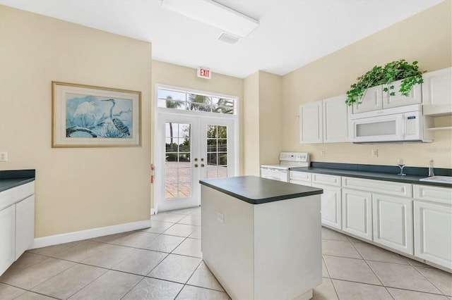 kitchen with french doors, white cabinetry, range with electric cooktop, and light tile patterned floors