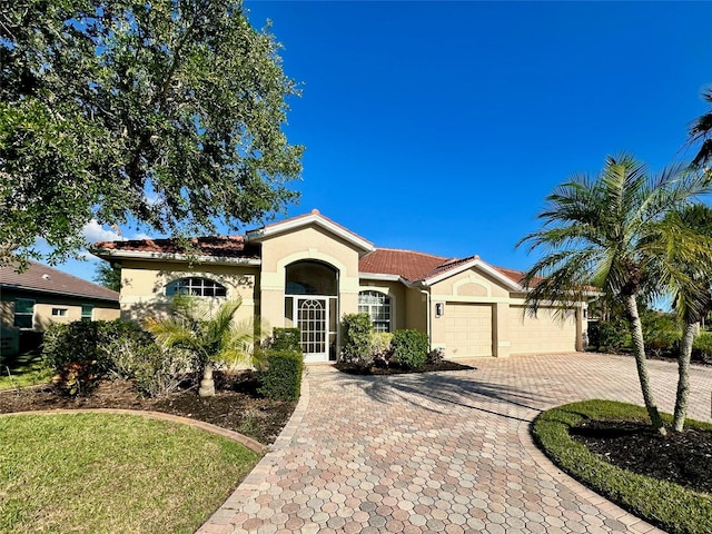 2921 Seasons Blvd, Sarasota, FL 34240 - mediterranean / spanish home with stucco siding, a garage, and decorative driveway