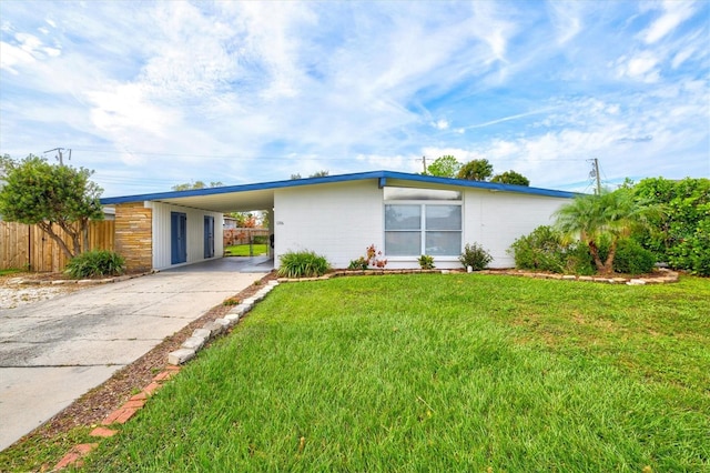 ranch-style home with a front yard and a carport