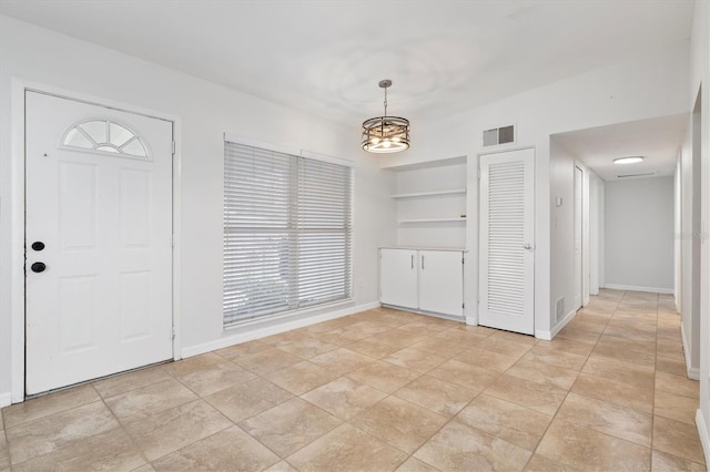 foyer featuring a chandelier