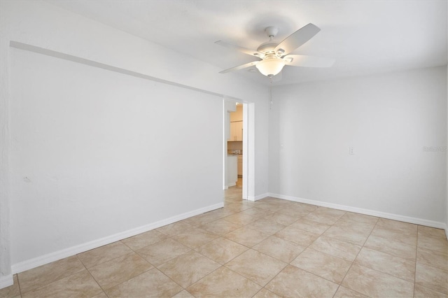 spare room featuring ceiling fan and light tile patterned floors