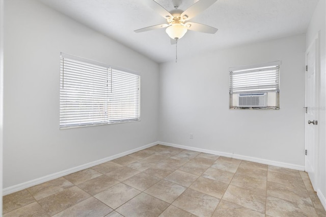 empty room featuring ceiling fan, cooling unit, and light tile patterned floors