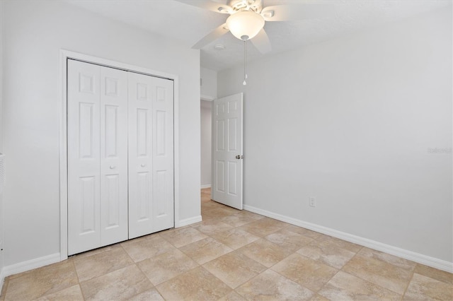 unfurnished bedroom with ceiling fan and a closet