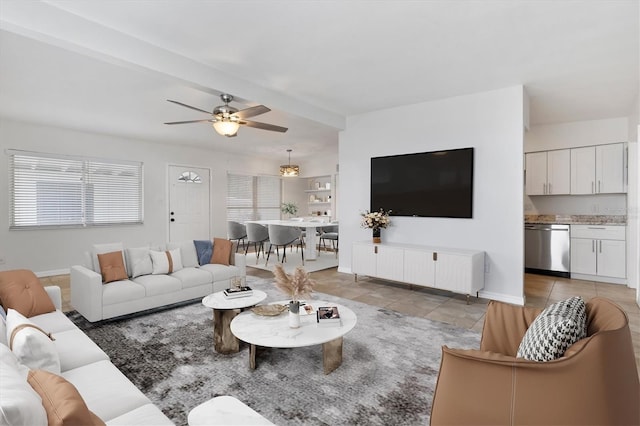 living room with ceiling fan and beamed ceiling