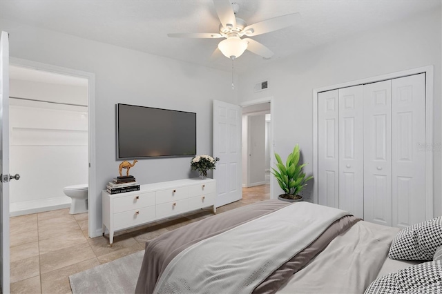 bedroom with connected bathroom, ceiling fan, a closet, and light tile patterned floors