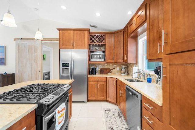 kitchen with pendant lighting, vaulted ceiling, light tile patterned floors, backsplash, and stainless steel appliances