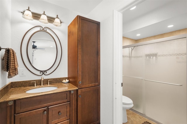 bathroom with vanity, an enclosed shower, and toilet