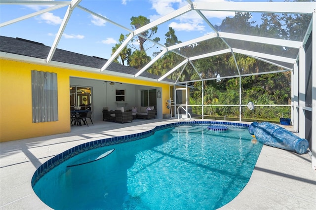 view of pool with a lanai, an outdoor living space, ceiling fan, and a patio