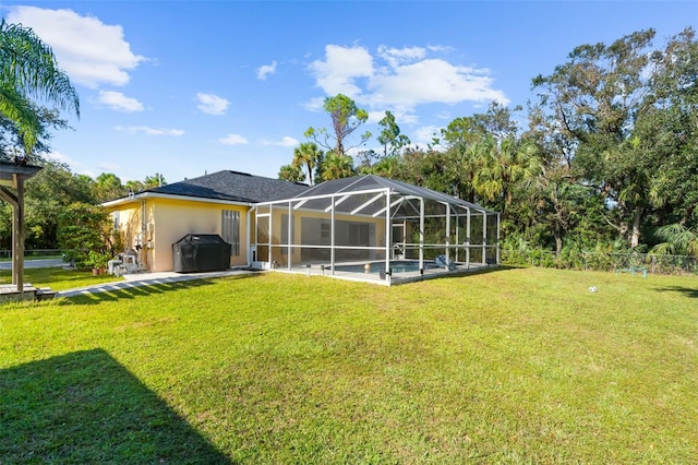 rear view of property featuring a lanai and a lawn