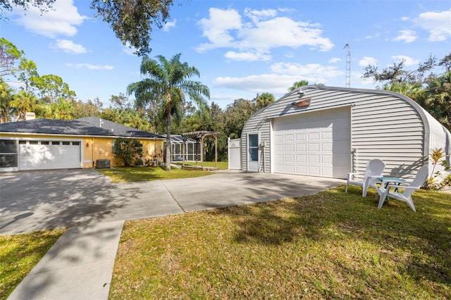 garage with central AC and a lawn