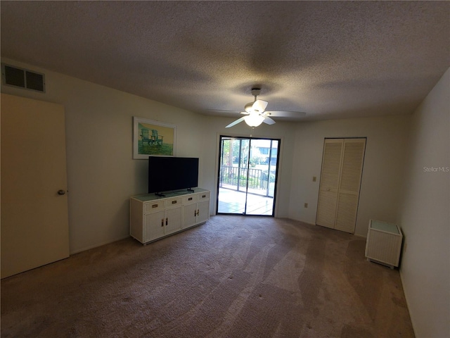 unfurnished living room with carpet flooring, radiator heating unit, a textured ceiling, and ceiling fan