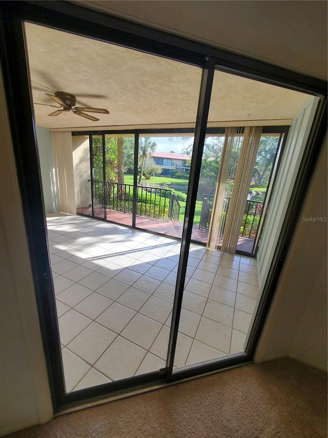 interior space with ceiling fan and carpet floors