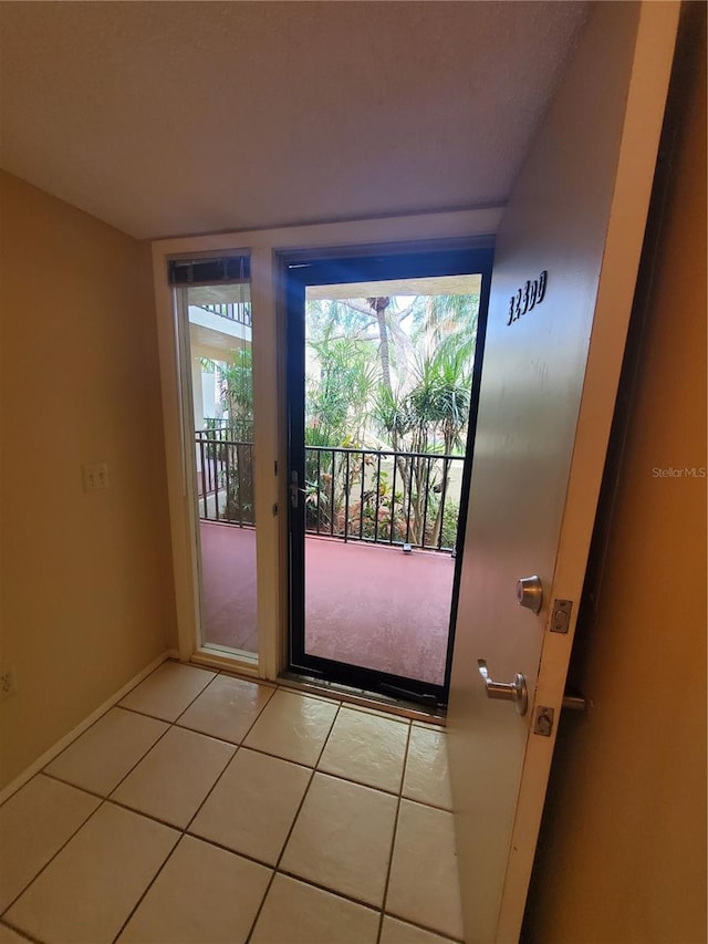 doorway with tile patterned floors